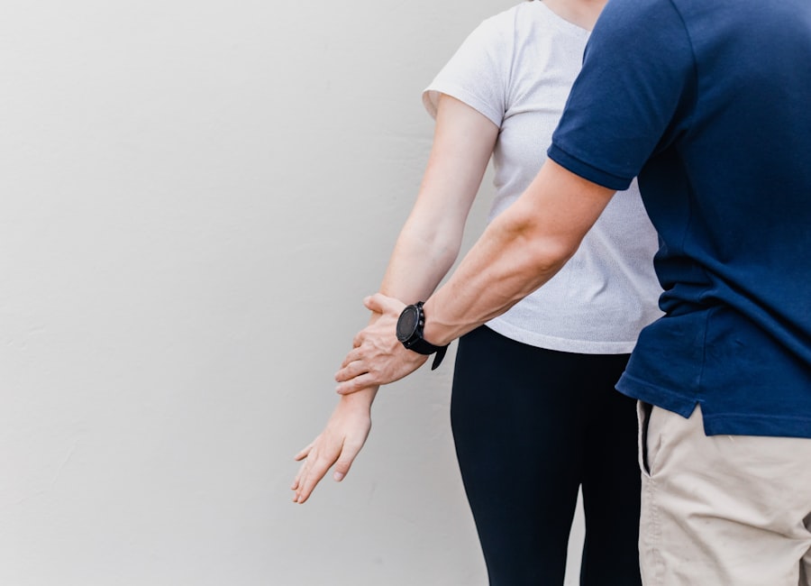 Therapeut dehnt den Arm einer Patientin